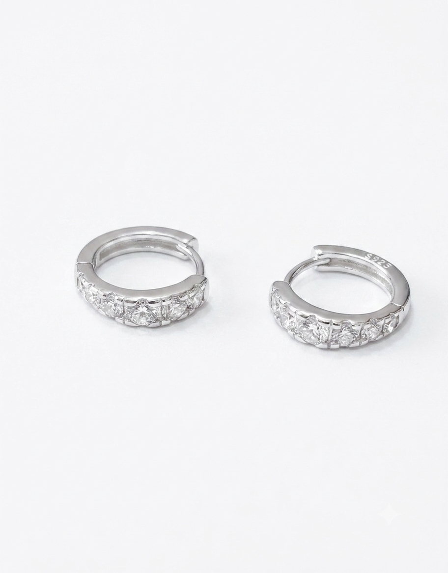 A pair of 14mm 925 Sterling silver huggie hoop earrings set with clear pavé cubic zirconia stones 