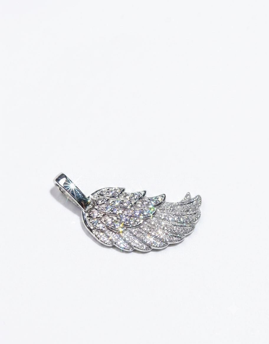 A silver-toned wing pendant encrusted with clear pavé stones,