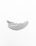 Load image into Gallery viewer, A silver angel wing pendant with detailed textured feathers
