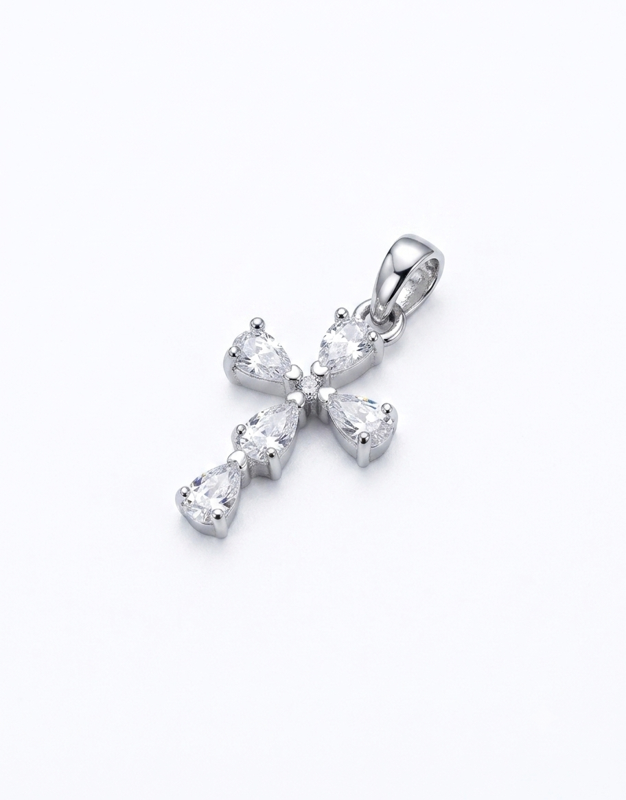 A silver cross pendant featuring pear-cut clear cubic zirconia stones 