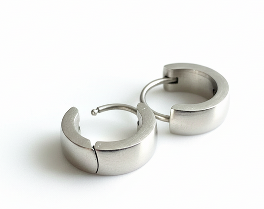 Curved Huggie Earrings on marble