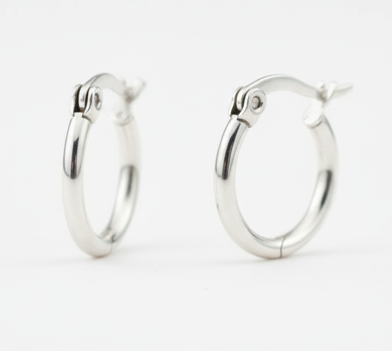 Pair of silver hoop earrings on white background
