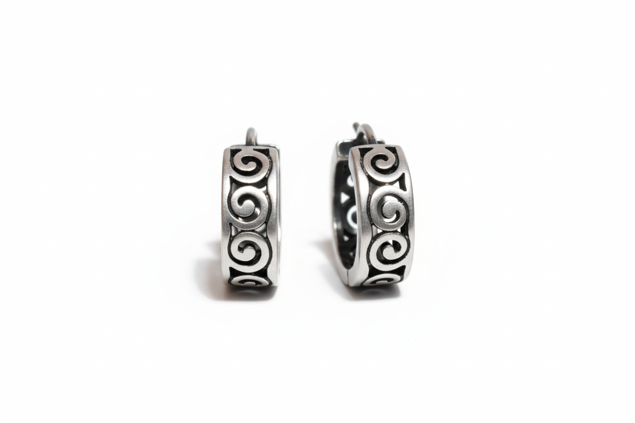 Pair of silver hoop earrings with intricate designs 